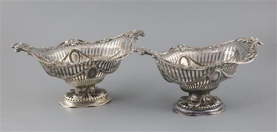 A pair of Victorian pierced silver boat shaped pedestal dishes, maker G.F.?, 28oz.